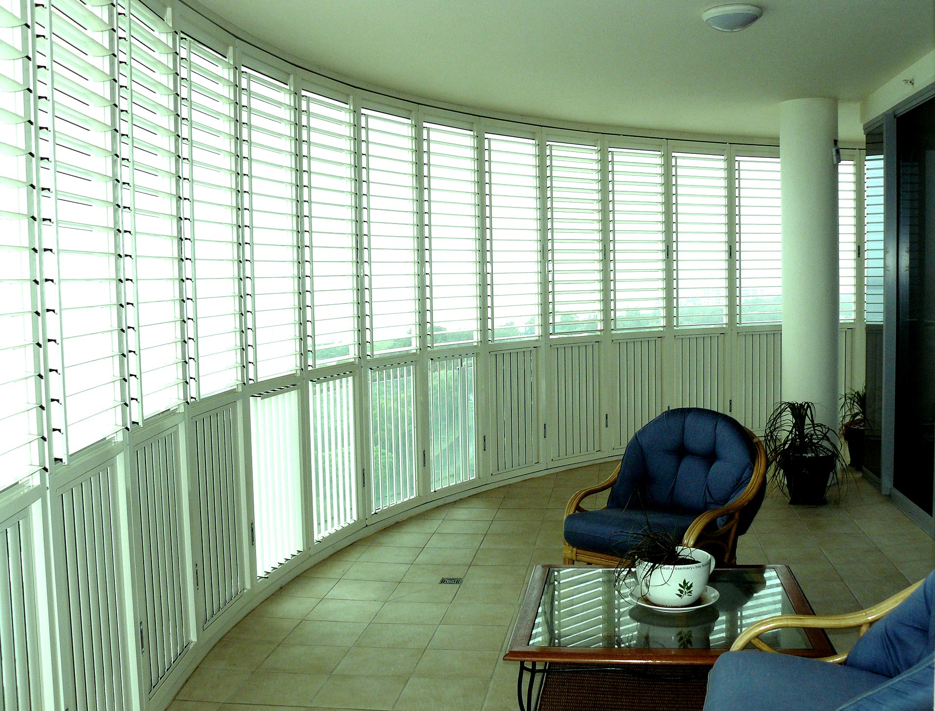 White outdoor shutters creating an outside room across a balcony